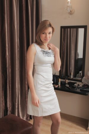 Alisia strips from her dress and stockings on the bed