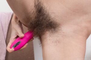 Nerdy girl in glasses from We Are Hairy sticks her pink dildo into her hairy cunny - Efina_PinkTopRedSkirt_096