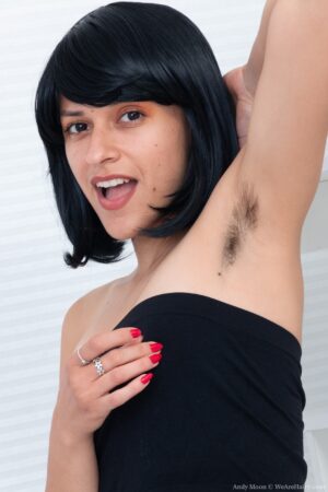 Fit hairy girl Andy Moon wearing a wig bends over spreading her droopy lips