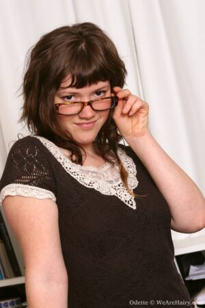 Curvy brunette in glasses Odette is hard at work satisfying her sexual cravings