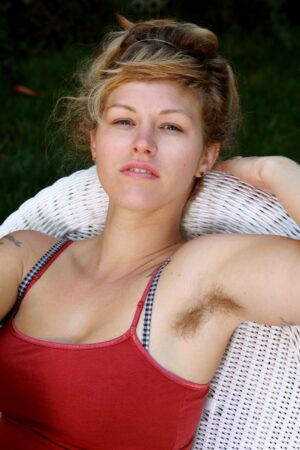Spunky blonde amateur Lilah rubs her hairy pussy outside