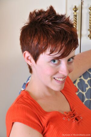 Short haired RyAnne bends over and gives view to her bush
