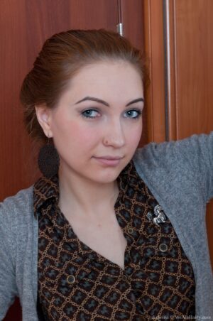 Hot business woman Sabrina strips and rubs her hairy pussy