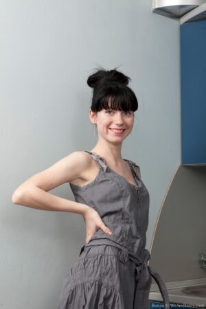 Bonya stripping in the kitchen with sheer grey stockings on